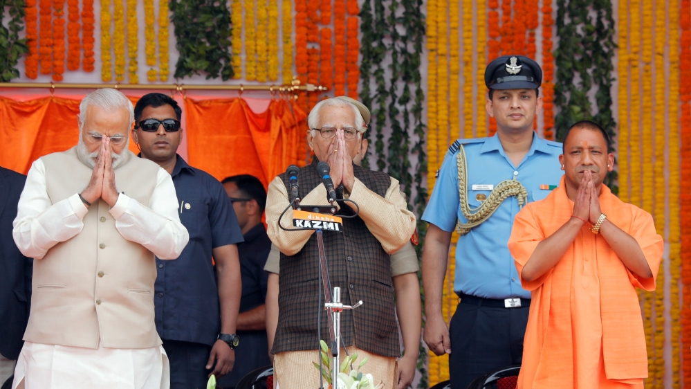 PM Narendra Modi, Uttar Pradesh governor Naik and India’s ruling BJP leader Adityanath greet a gathering before Adityanath takes an oath as the new Chief Minister of India’s most populous state of Utt
