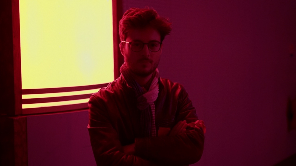 A young man guards the stage at a rally for French presidential candidate, Philippe Poutou [Shafik Mandhai/Al Jazeera]