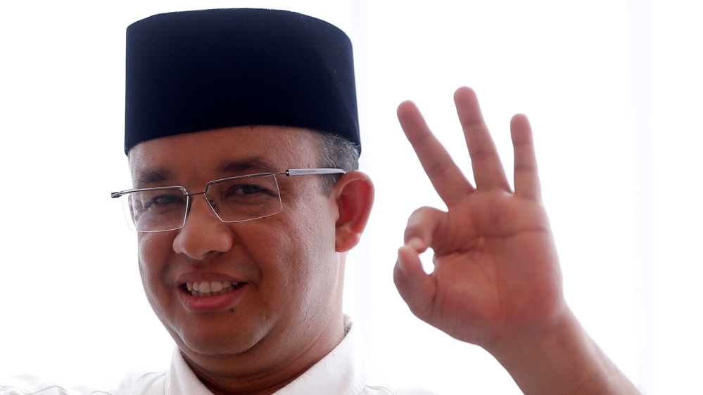 Candidate governor Anies Baswedan casts his vote in the Jakarta governor election in South Jakarta