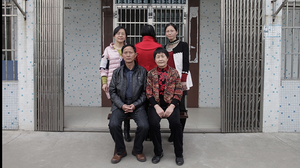 Lin Chunhong (with her back to the camera), her birth parents and her two older sisters in Jiangyin, eastern China [Han Meng/Al Jazeera]
