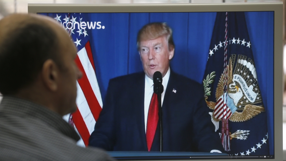 Russians watch US President Donald J. Trump announcing US strikes in Syria