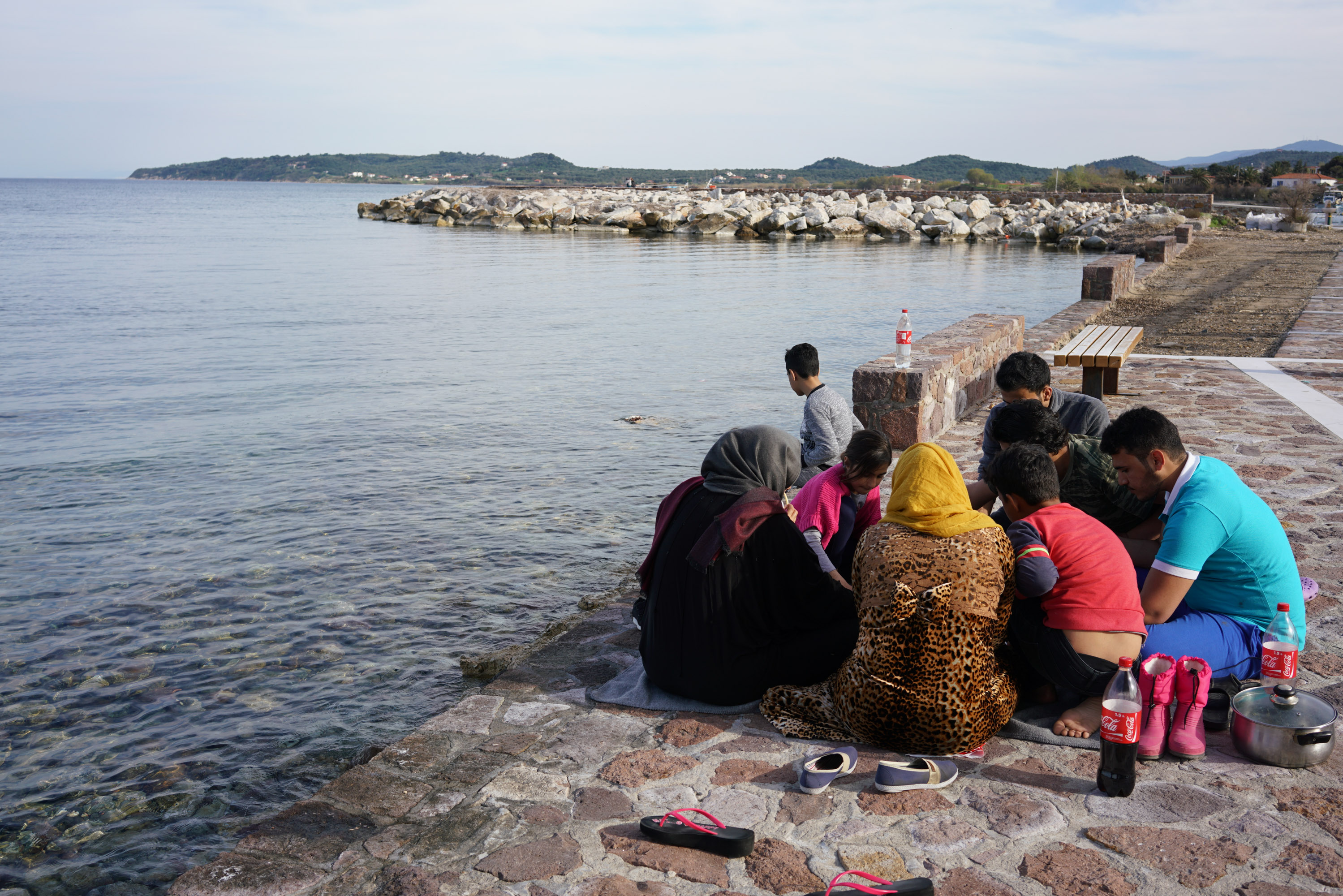 The Alsamaray family picnic with a Syrian family who live in a nearby hotel in Thermis [Talitha Brauer/Al Jazeera]