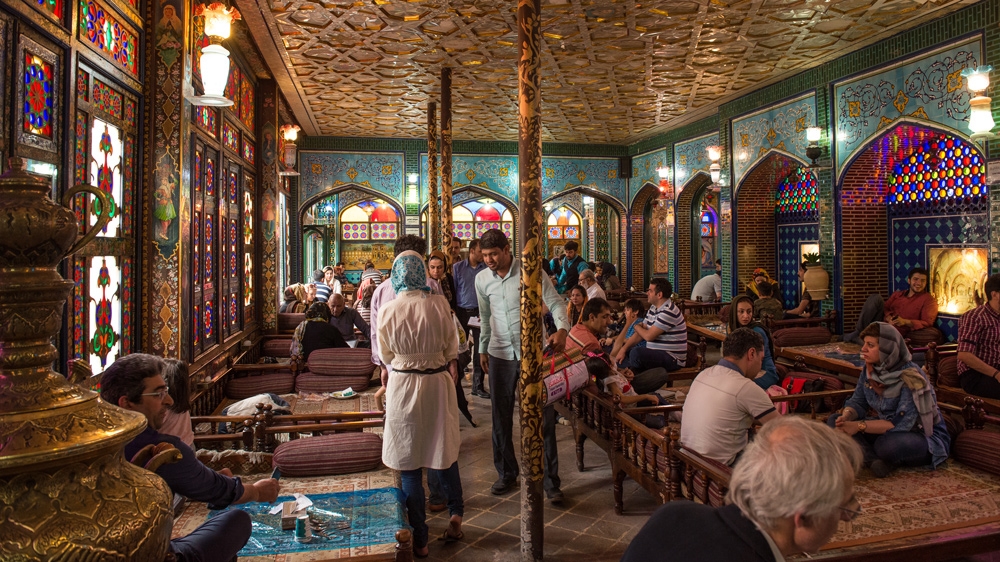 Outside this restaurant in Naqshe Jahan Square, a long queue of people wait to be seated for lunch [Wojtek Arciszewski/Al Jazeera]