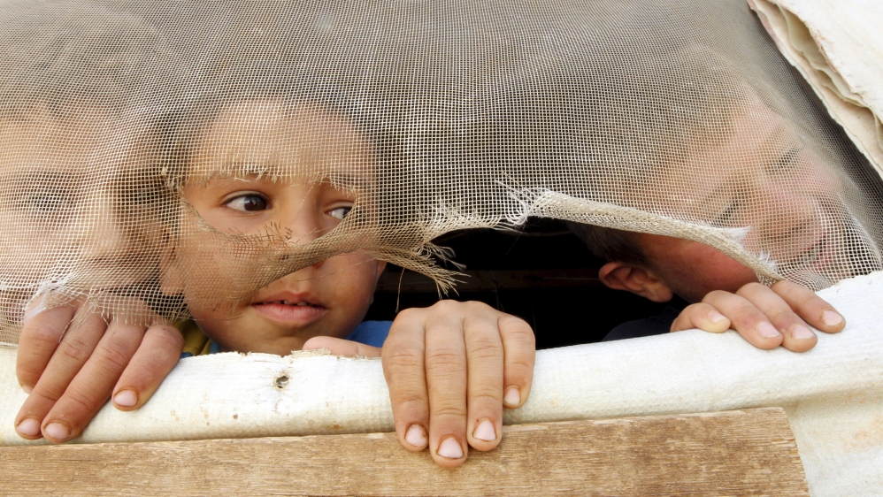 FILE PHOTO: Syrian refugee children look out from their tent in Saadnayel in Lebanon''s Bekaa Valley