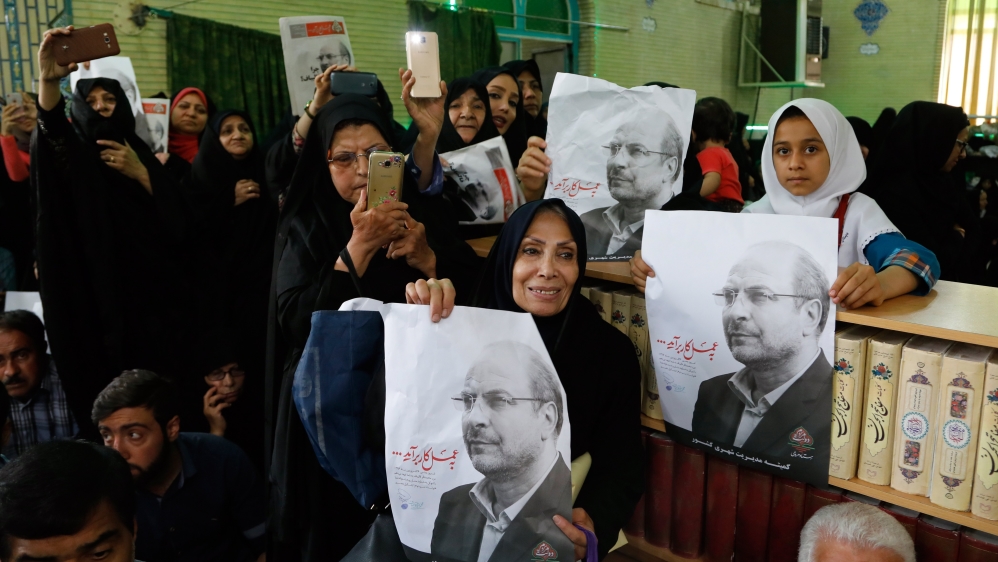 Supporters of Iranian presidential candidate Mohammad Bagher Ghalibaf hold his pictures during an election campaign rally in Jame mosque in the city of Varamin, Iran [EPA]