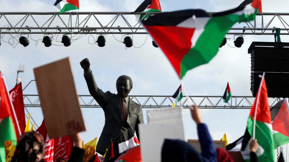 The Nelson Mandela statue is seen as demonstrators take part in a rally in support of Palestinian prisoners on hunger strike in Israeli jails, in the West Bank city of Ramallah