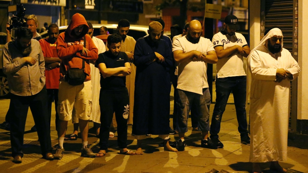 Men pray after a vehicle struck pedestrians near a mosque in the Finsbury Park area of north London [Neil Hall/Reuters]