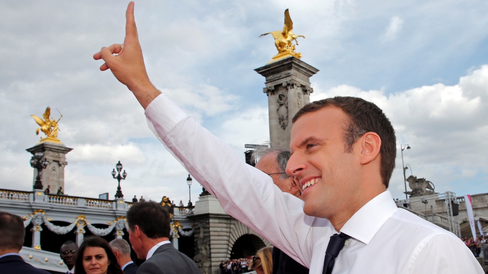 French President Emmanuel Macron waves to the crowd in Paris