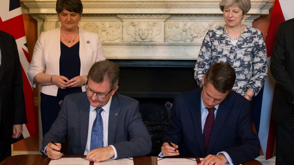Democratic Unionist Party leader Arlene Foster and Britain''s Prime Minister Theresa May pose for a photograph as paperwork is signed inside 10 Downing Street, London