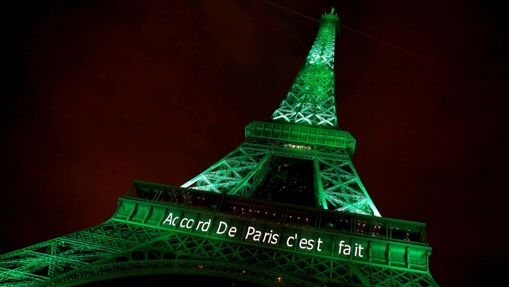 FILE PHOTO: The Eiffel tower is illuminated in green with the words "Paris Agreement is Done", to celebrate the Paris U.N. COP21 Climate Change agreement in Paris