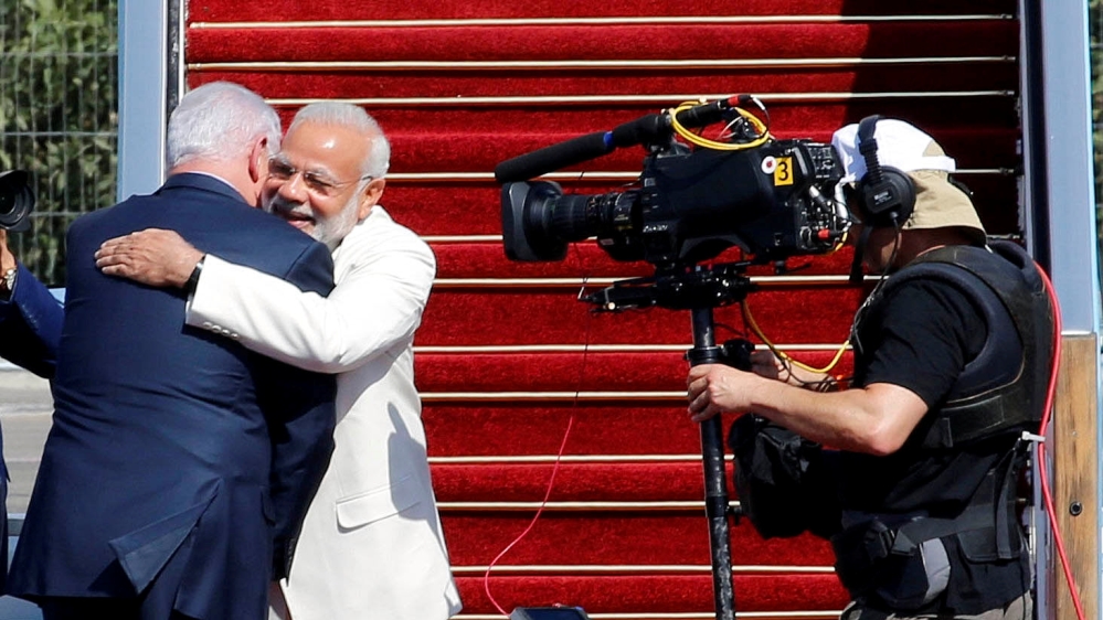 Israeli Prime Minister Benjamin Netanyahu hugs Indian Prime Minister Narendra Modi during an official welcoming ceremony upon his arrival to Israel at Ben Gurion Airport