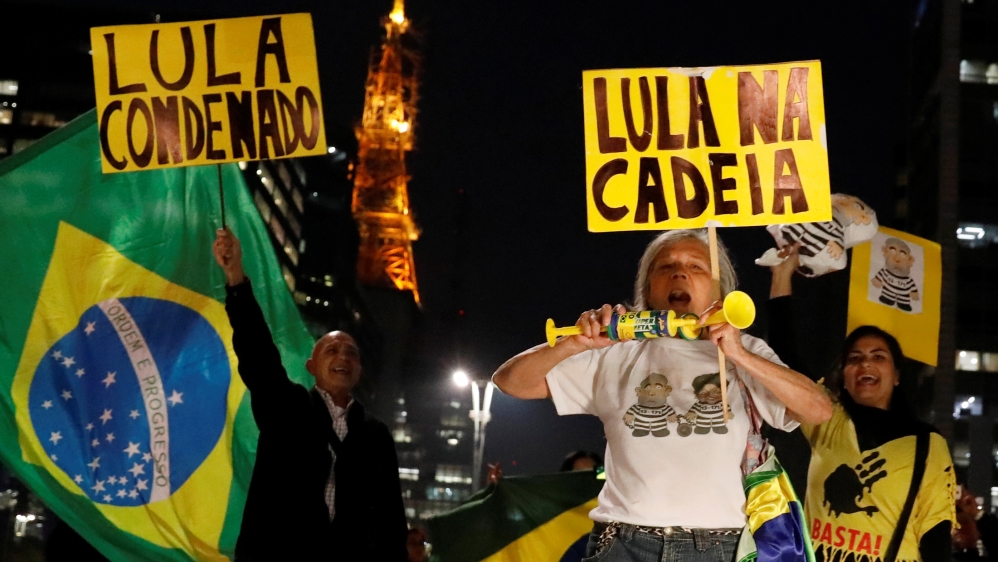 People celebrate after former Brazilian President Luiz Inacio Lula da Silva, was convicted on corruption charges and sentenced to nearly 10 years in prison in Sao Paulo