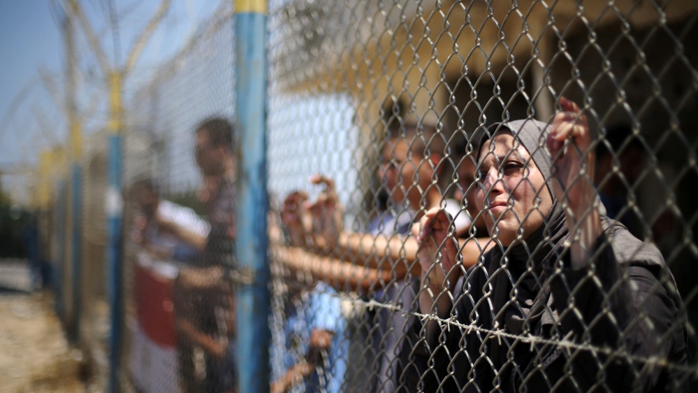 Palestinians gather in front of the gate of Rafah border crossing between Egypt and Gaza during a protest