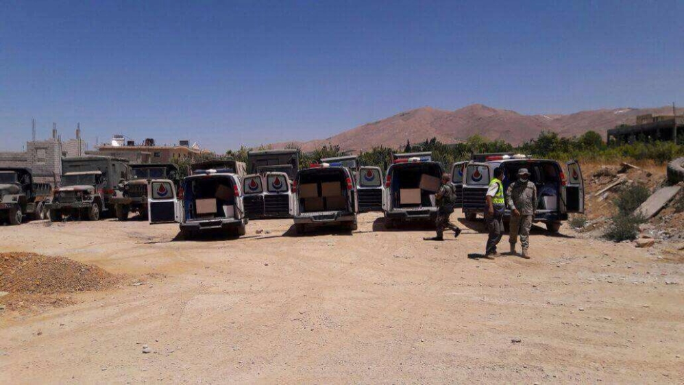 Hezbollah ambulances are seen carrying the coffins of bodies of Nusra Front fighters in Labwe
