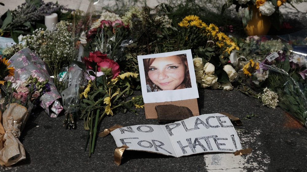 Flowers and a photo of car ramming victim Heather Heyer lie at a makeshift memorial in Charlottesville, Virginia,
