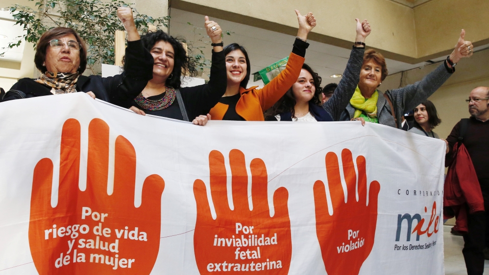 Deputies of the Socialist and Communist party hold a placard after approval of a bill to legalize abortion in certain cases during a session at Chile''s Chamber of Deputies in Valparaiso