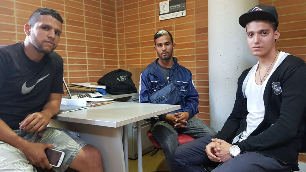 Venezuelan father of two Eduard Sanche, pictured in a black t-shirt, and his two friends arrived in Soacha in April from their home of Maracay. Eduard was forced to leave his wife and two children behind because he couldn't afford to pay the transport costs. He's struggled to find work and says life is tough in Soacha but he's earning enough as a labourer to feed his family in Venezuela [Dimitri O'Donnell/Al Jazeera]