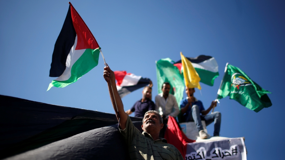 Palestinians celebrate after Hamas said it reached a deal with Palestinian rival Fatah, in Gaza City