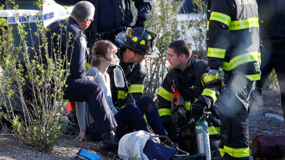 A woman is aided by first responders after sustaining injury on a bike path in lower Manhattan in New York