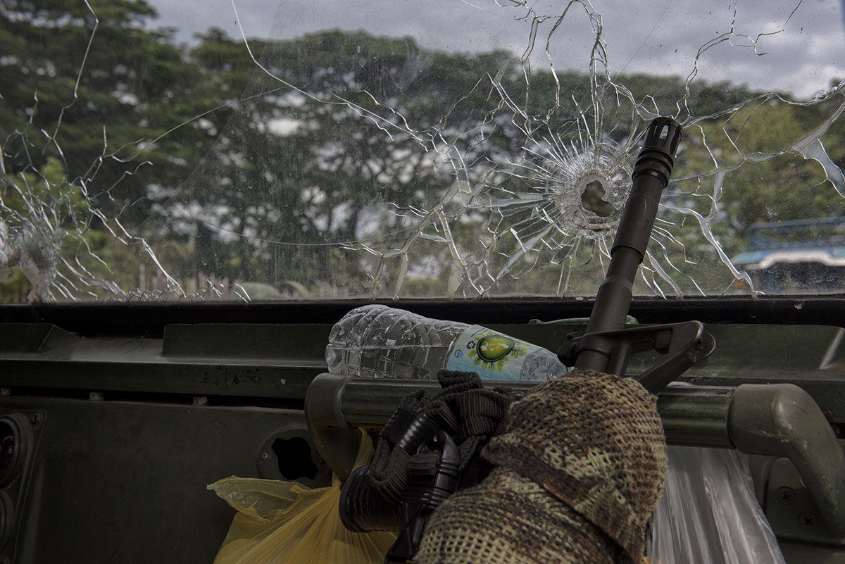 A soldier''s rifle inside a military vehicle with bullet hole ridden windshield as troops get ready to leave the battle against IS-inspired militants on October 20, 2017 in Saguiaran town in Lanao del