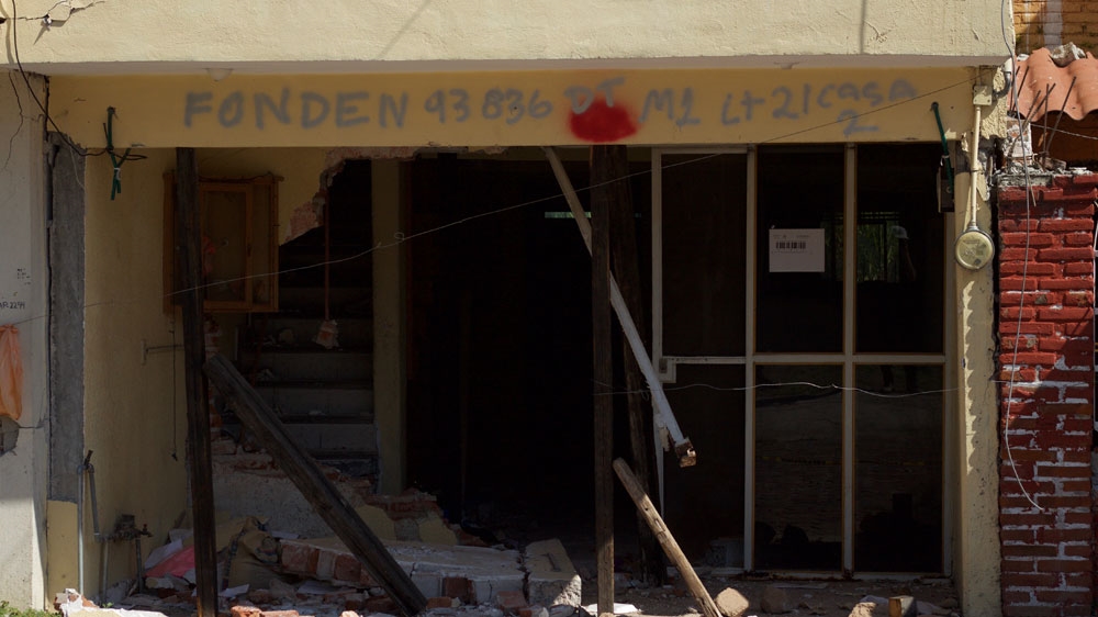 Houses that have been condemned have been marked with red spray paint [Simon Schatzberg/Al Jazeera]