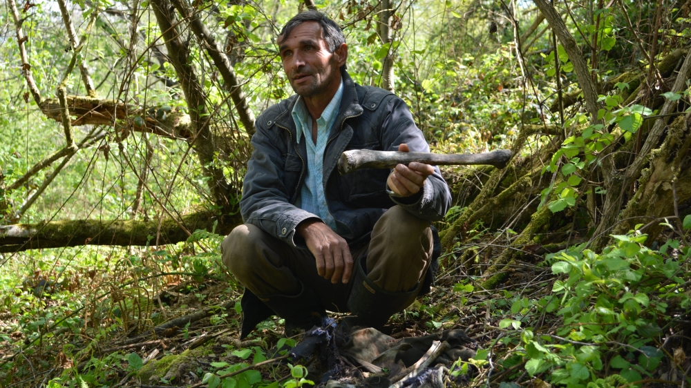 Ramiz Nukic spends his days searching for the remains of war victims in the fields [Mersiha Gadzo/Al Jazeera]