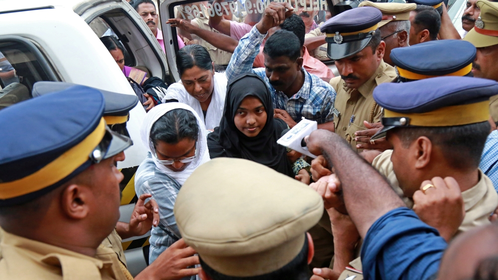 Akhila, who converted to Islam in 2016 and took a new name, Hadiya, arrives at the airport in Kochi