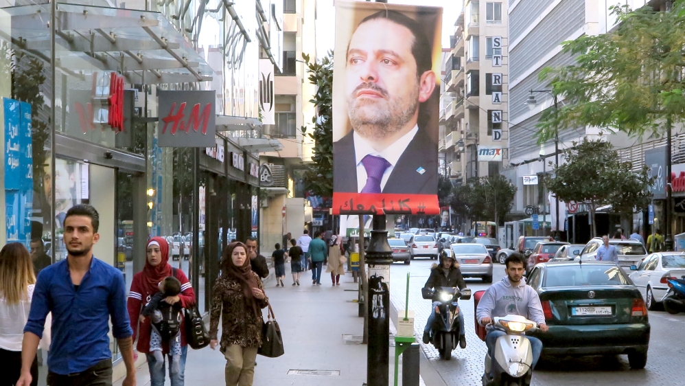 A poster showing Lebanese Prime Minister Saad al-Hariri, who announced his resignation from Saudi Arabia, is seen in Beirut