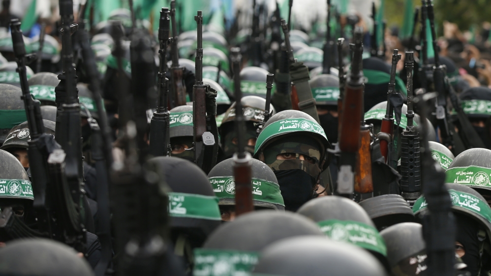 Palestinian members of al-Qassam Brigades take part in a military parade in Gaza City