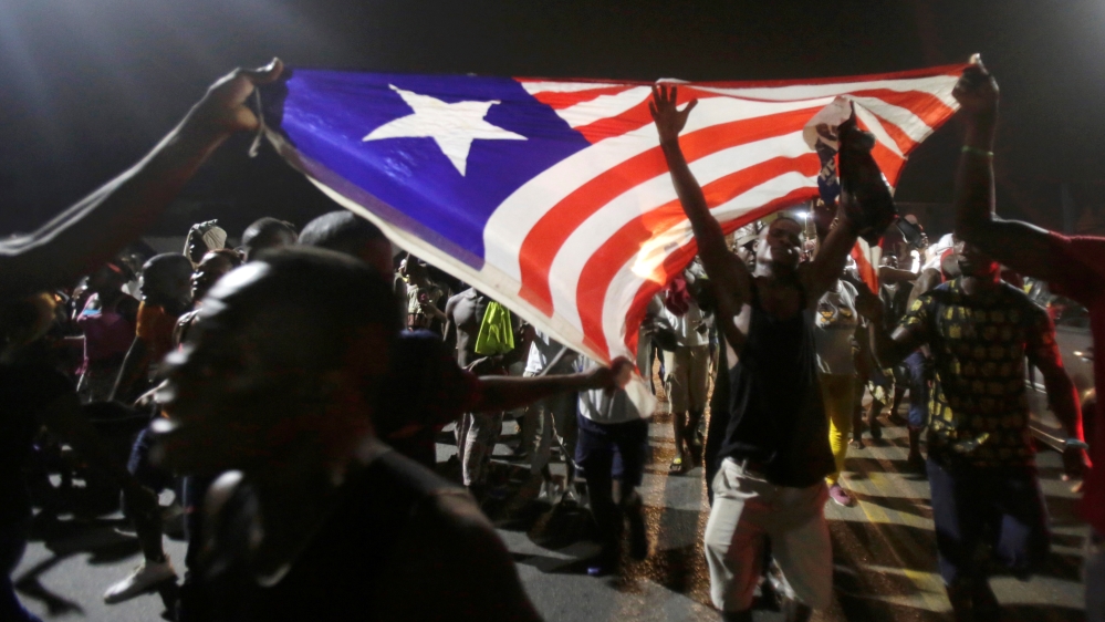 Weah's supporters celebrate the final election results in Monrovia [Thierry Gouegnon/Reuters]
