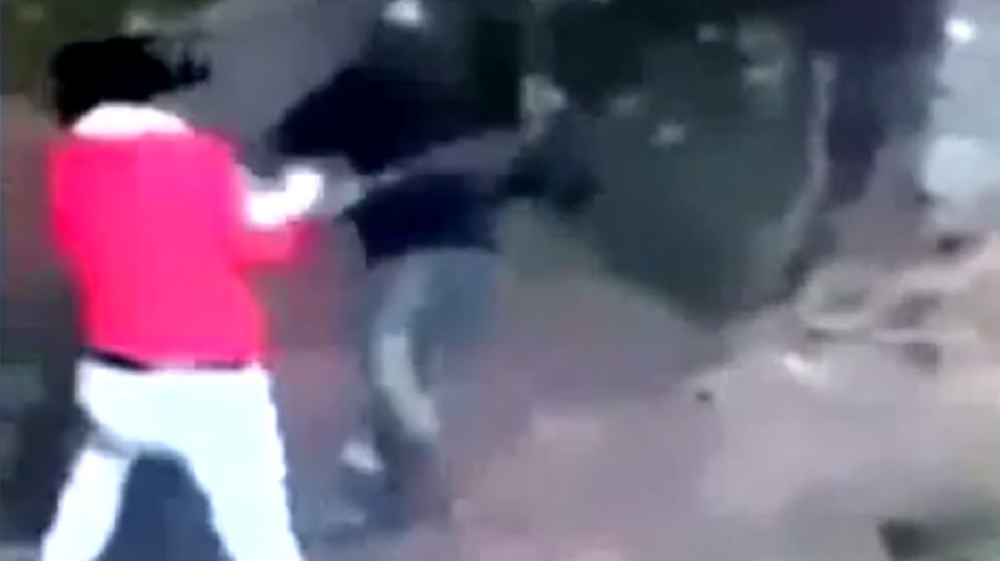 An image of the alleged attacker hacking at his victim [Screen-grab]