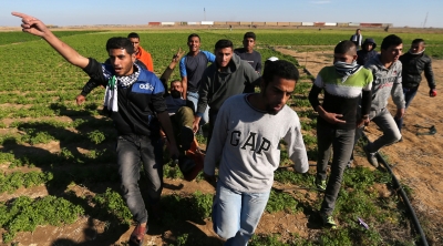 A wounded Palestinian protester is evacuated during clashes with Israeli troops in the southern Gaza Strip [Ibraheem Abu Mustafa/Reuters]