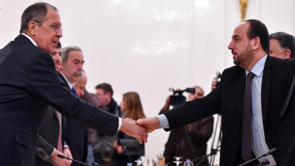 Russian Foreign Minister Sergei Lavrov shakes hands with Syria's opposition chief negotiator Nasr al-Hariri during a meeting in Moscow on January 22, 2018 [Vasily Maximov/AFP]