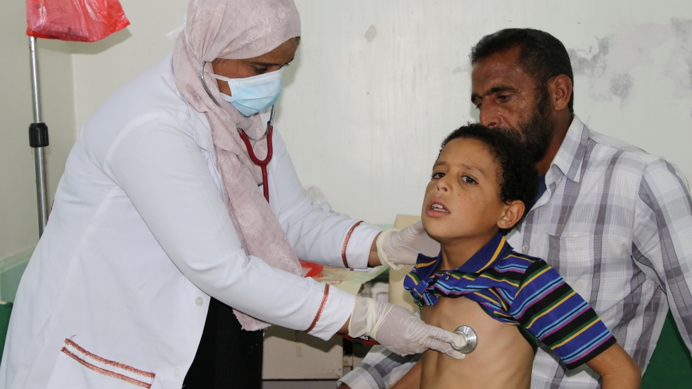 Nahla Arishi, a pediatrician, checks a boy infected with diphtheria at the al-Sadaqa teaching hospital in the southern port city of Aden