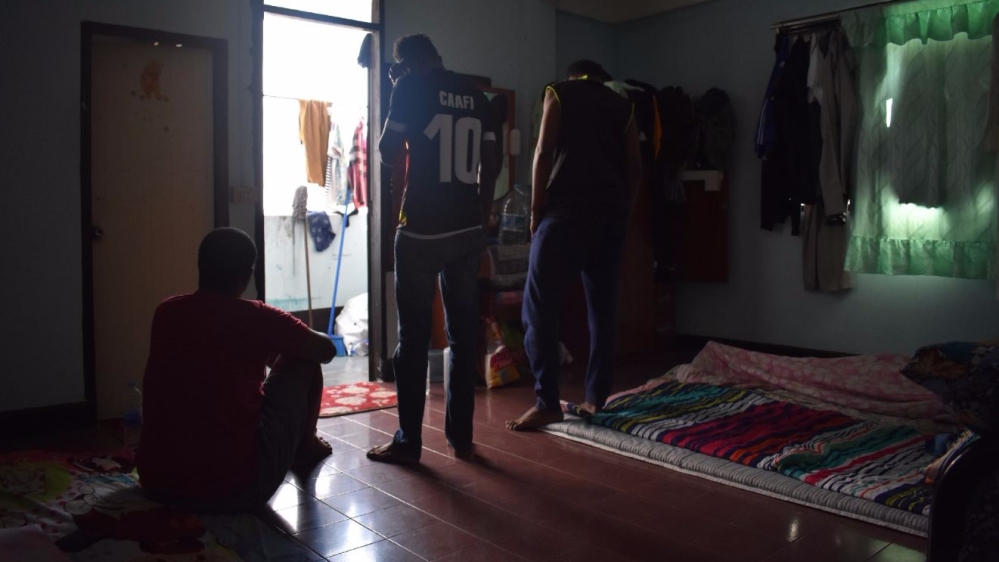 Abdirahim, centre, does not leave this shared room for fear of arrest by authorities [Alastair G M/Al Jazeera]