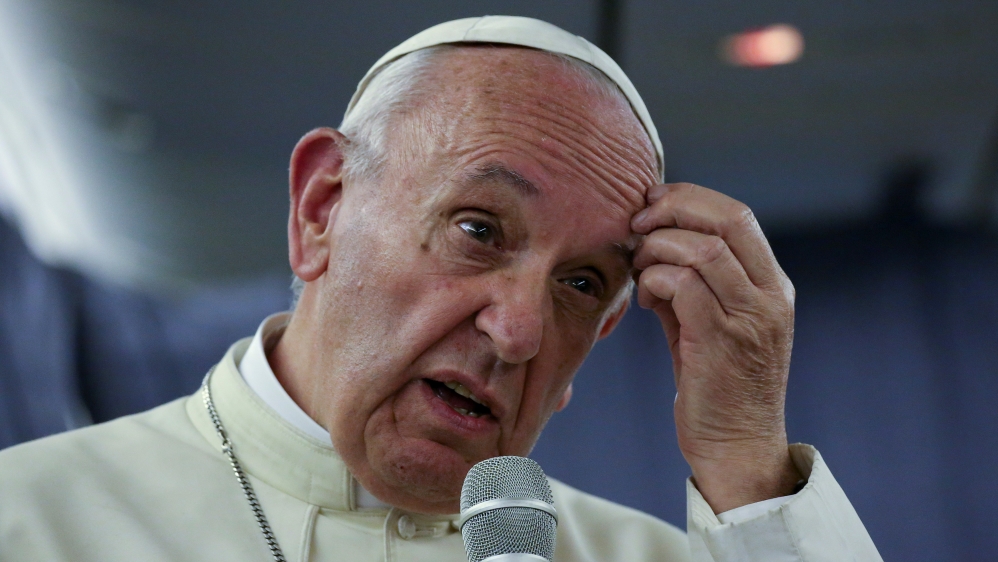 Pope Francis gestures during a news conference on board the plane during his flight back from a trip to Chile and Peru