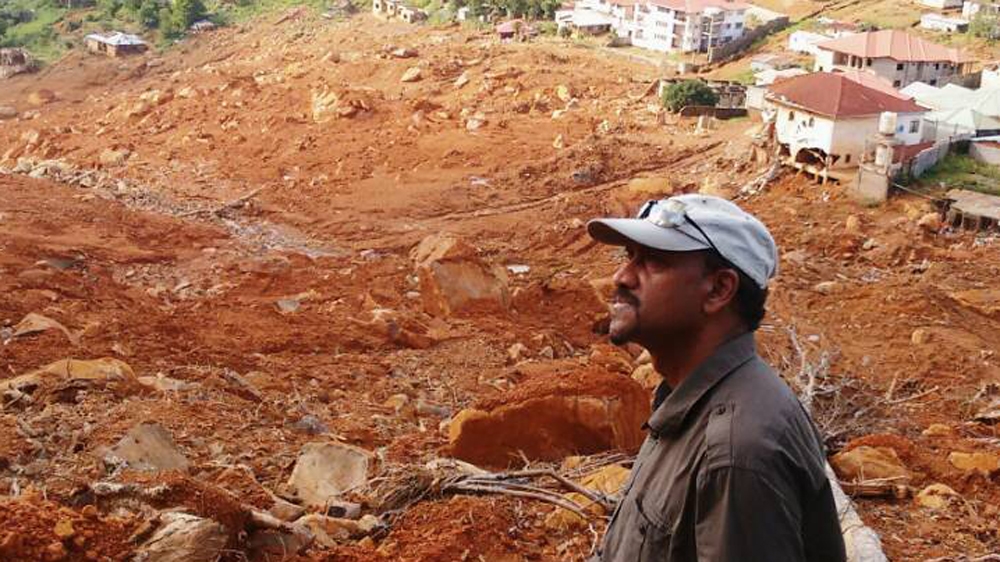 Bala Amarasekaran, founder and director of the Tacugama Chimpanzee Sanctuary, on Sugarloaf Mountain. [Al Jazeera]