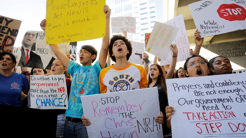 Students and others chant at a rally calling for more gun control three days after the shooting at a high school in Parkland, Florida [File: Jonathan Drake/Reuters]