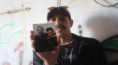 Mohamed tries to put on a happy face for his family [Shatha Hammad/Al Jazeera]