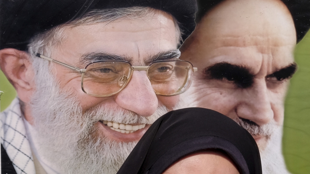 Iranian schoolgirl stands in front of Khomeini, and Khamenei