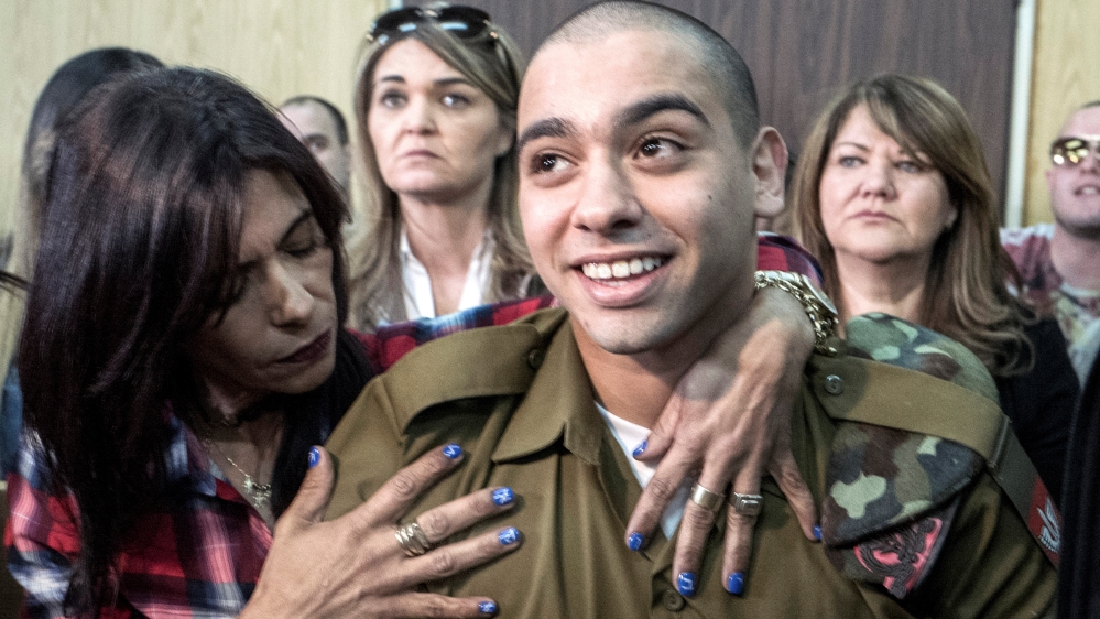 Israeli soldier Elor Azaria is embraced by his mother at the start of is sentencing hearing at a military court in Tel Aviv