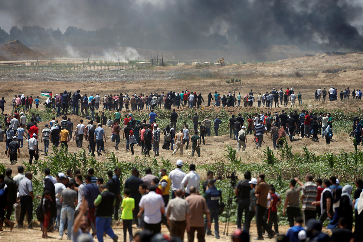 Palestinian demonstrators gather at the Israel-Gaza border during a protest against U.S. embassy move to Jerusalem and ahead of the 70th anniversary of Nakba, east of Gaza City May 14, 2018. REUTERS/M