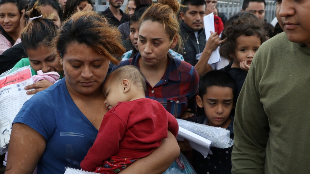 Undocumented immigrant families are released from detention at a bus depot in McAllen, Texas  [Loren Elliott/Reuters] 