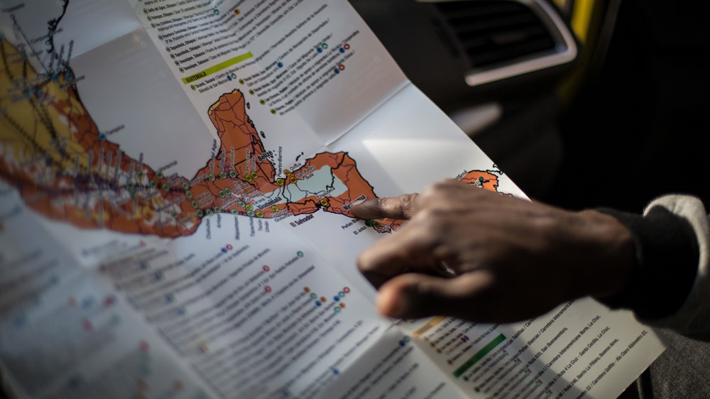 Yannick points out the path he took through Latin America to reach the United States [Walker Dawson/Al Jazeera]