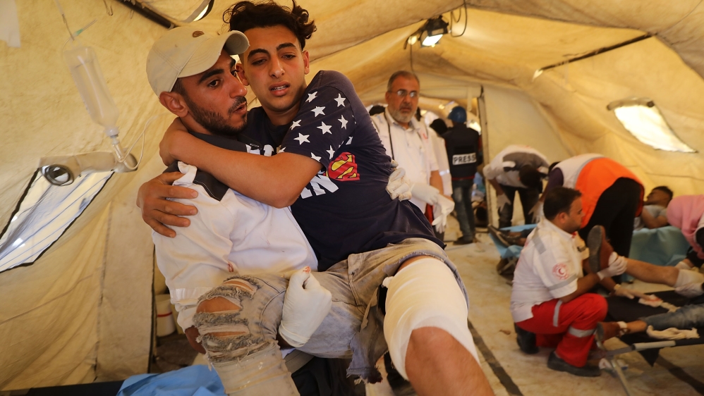 GAZA CITY, GAZA - MAY 14: A wounded Palestinian protester arrives at a field hospital near the border fence with Israel as mass demonstrations continue on May 14, 2018 in Gaza City, Gaza.
