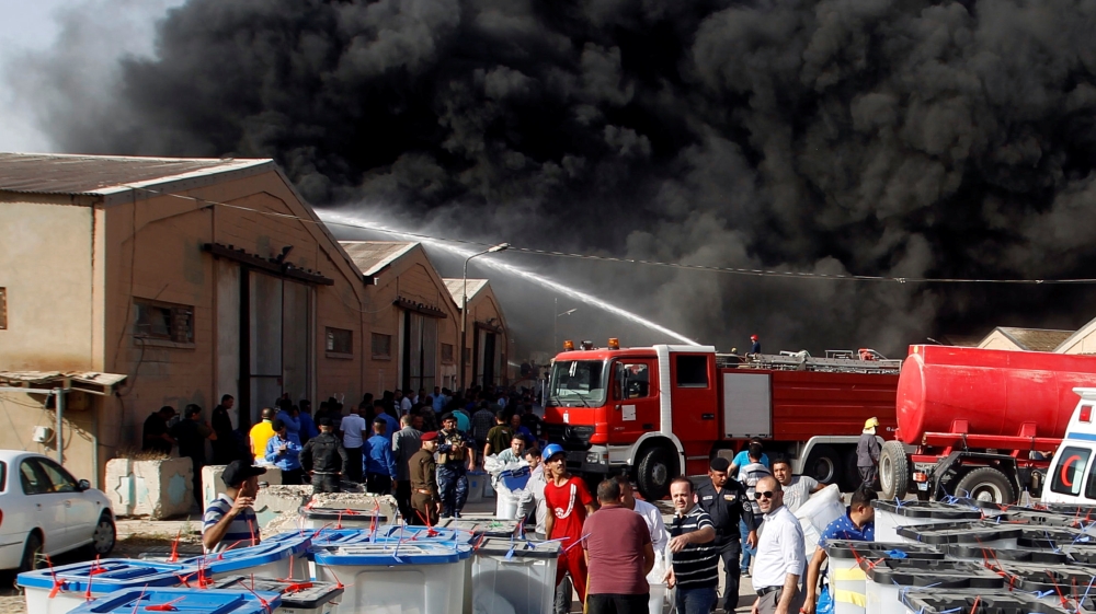 Smoke rises from a storage site in Baghdad, housing ballot boxes from Iraq''s May parliamentary election