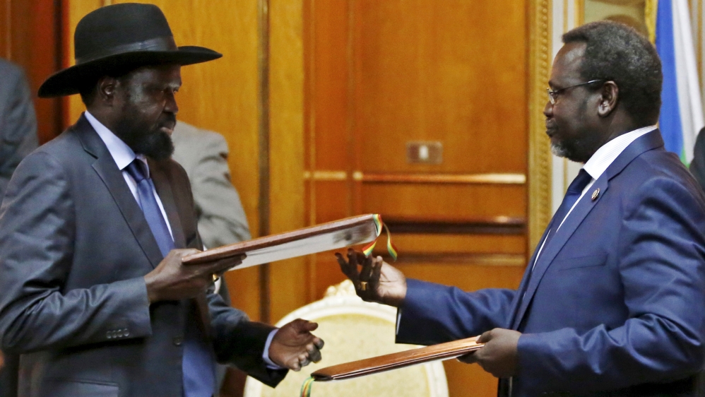 File photo shows South Sudan''s rebel leader Riek Machar and South Sudan''s President Salva Kiir exchanging signed peace agreement documents in Addis Ababa