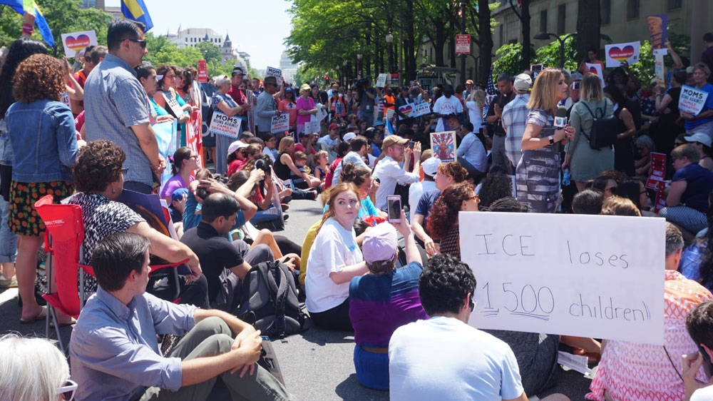 Protesters urged Trump to end family separations through the policy of prosecuting undocumented migrants [Azad Essa/Al Jazeera] 