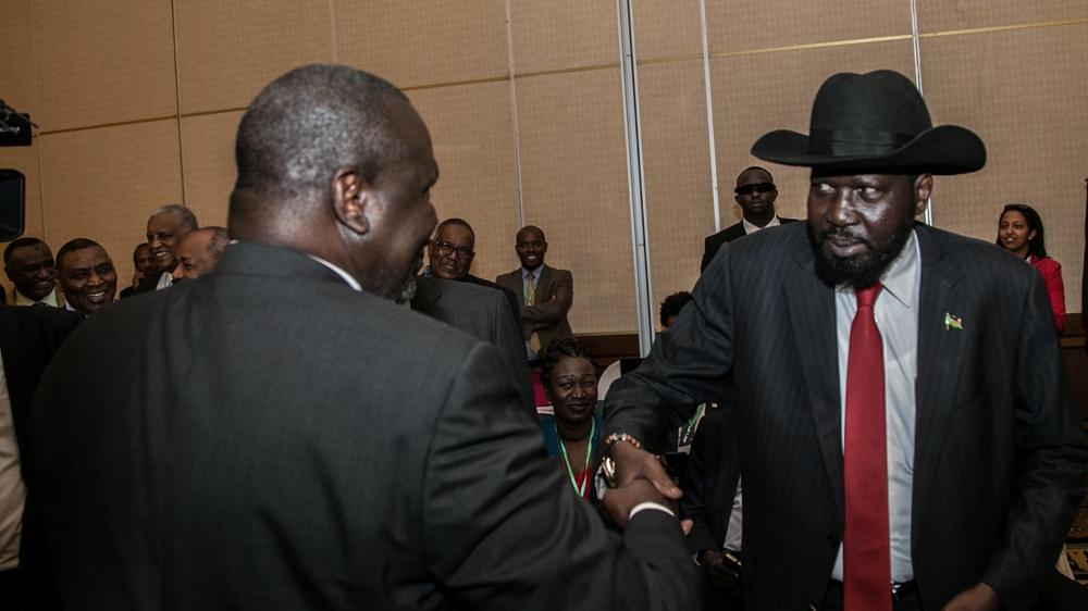 South Sudan President Salva Kiir (R) greets South Sudan Rebel leader Riek Machar during a peace meeting in Addis Ababa, Ethiopia [Reuters]