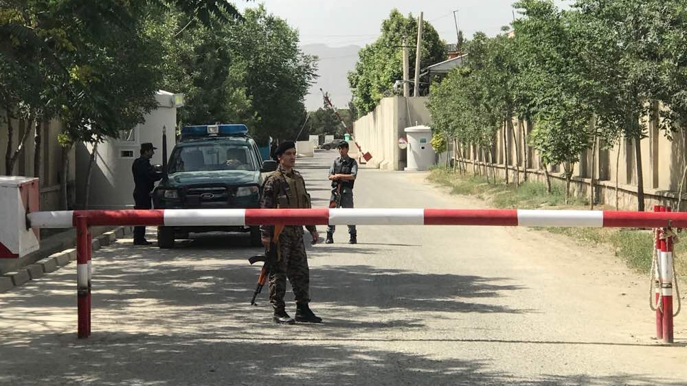 Afghan policemen keep watch near the site of a suicide attack in Kabul